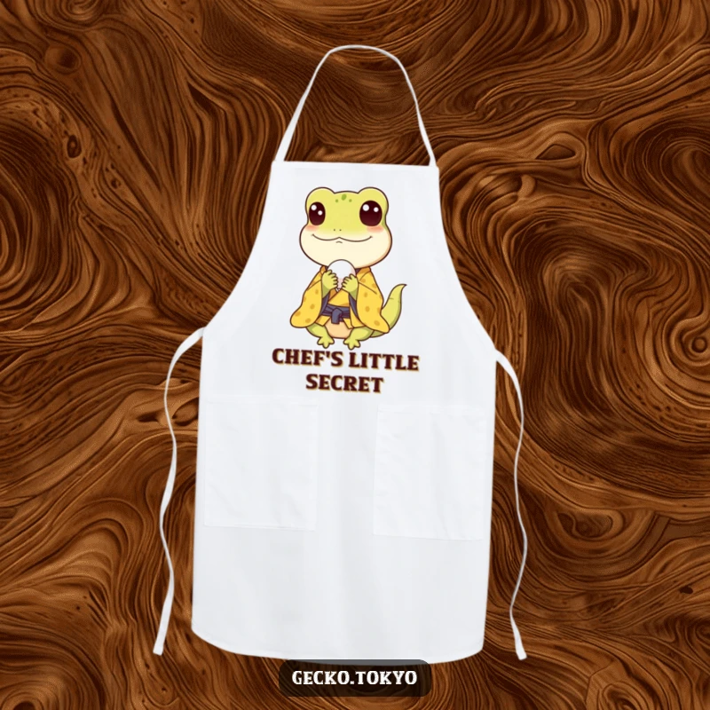 Funny gecko apron, happily munching a rice ball in a yellow kimono, adding culinary cheer to kitchen tasks, a practical funny gift.