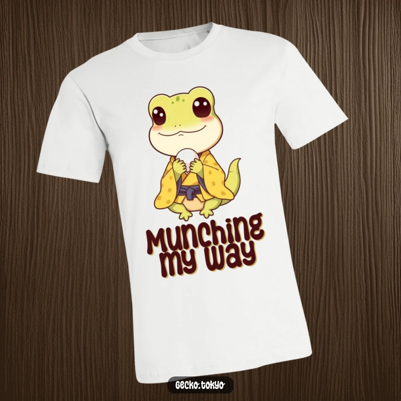 Funny gecko t-shirt, happily eating a small rice ball in a yellow kimono, capturing pure culinary bliss, a tasty funny gift.